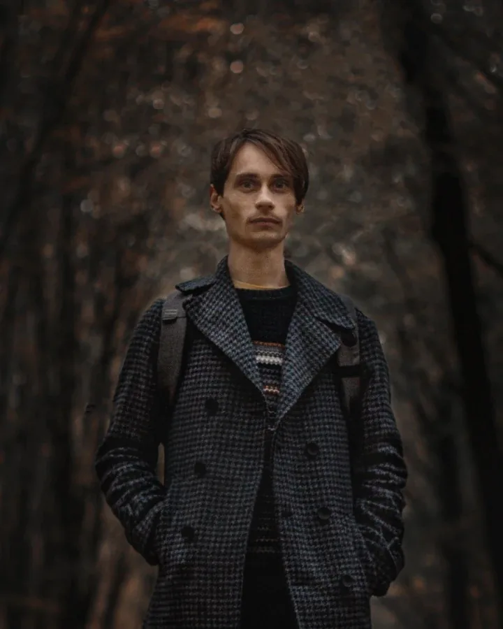 Viktor Khasenko in a grey houndstooth coat, in an autumn forest